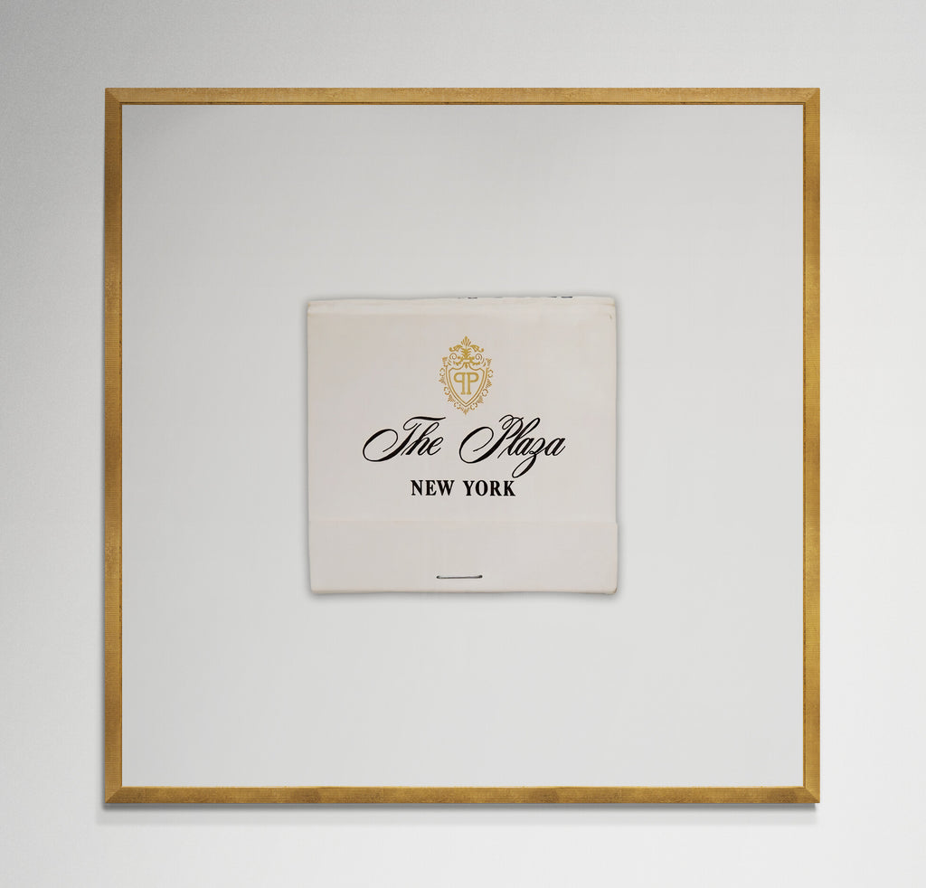 Plaza Hotel matchbook print in gold frame on wall