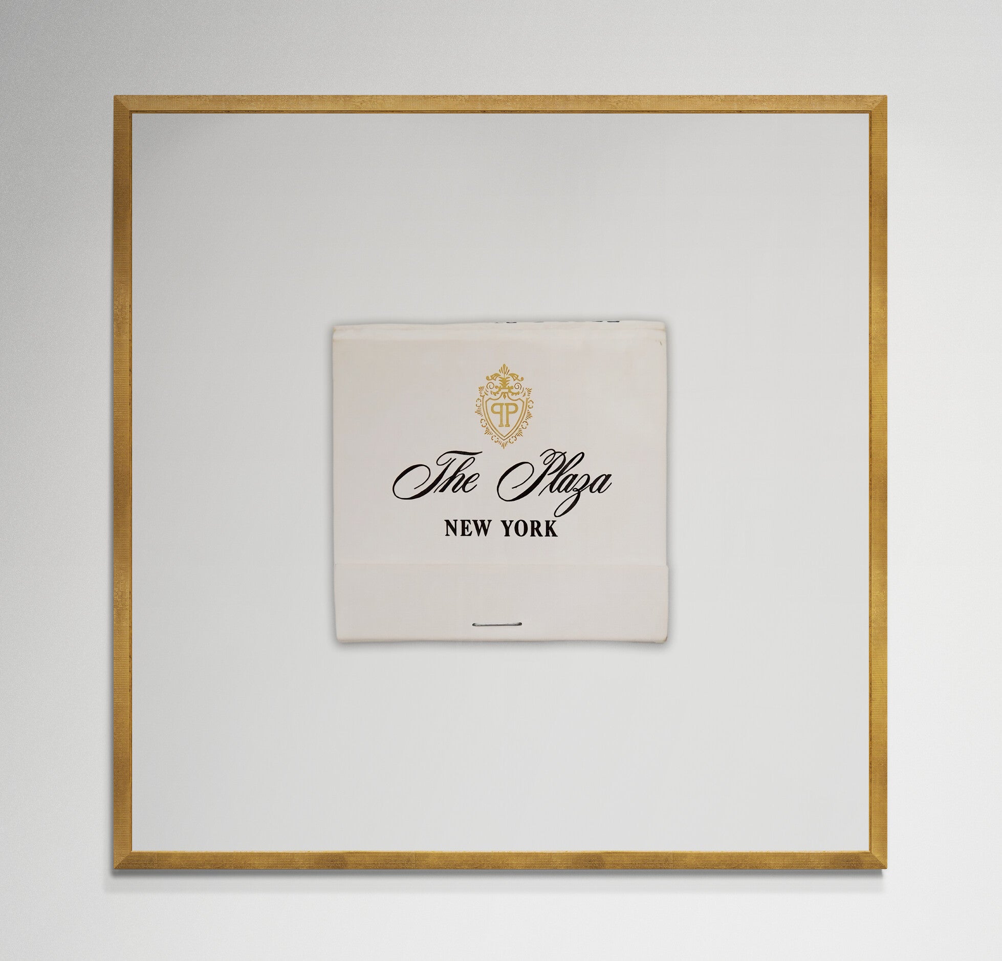 Plaza Hotel matchbook print in gold frame on wall