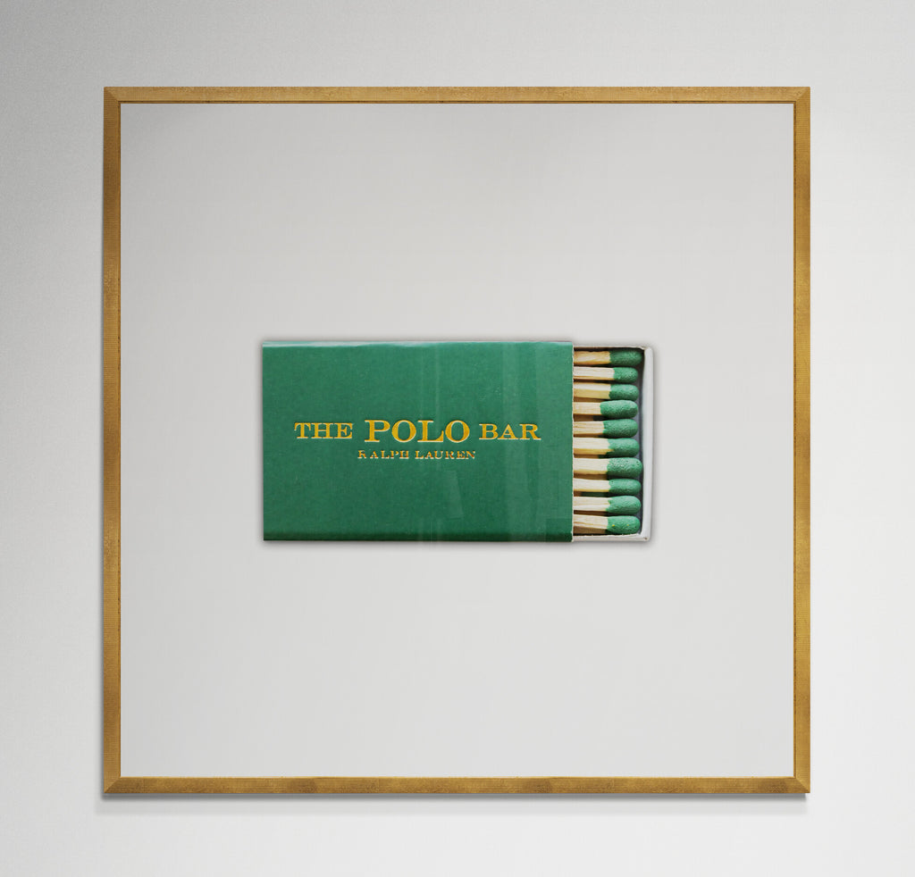 Polo Bar matchbook print in gold frame on wall