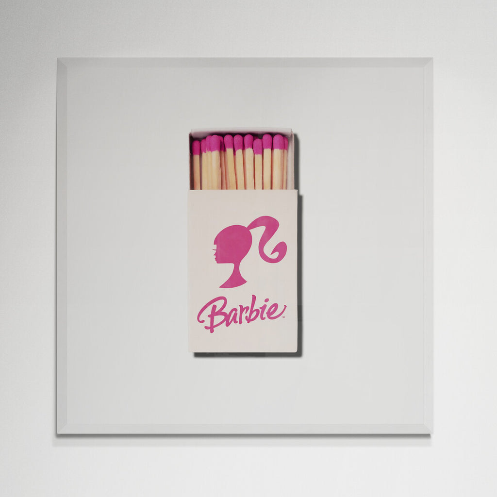 Barbie matchbox print in white frame on wall
