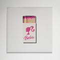 Barbie matchbox print in white frame on wall