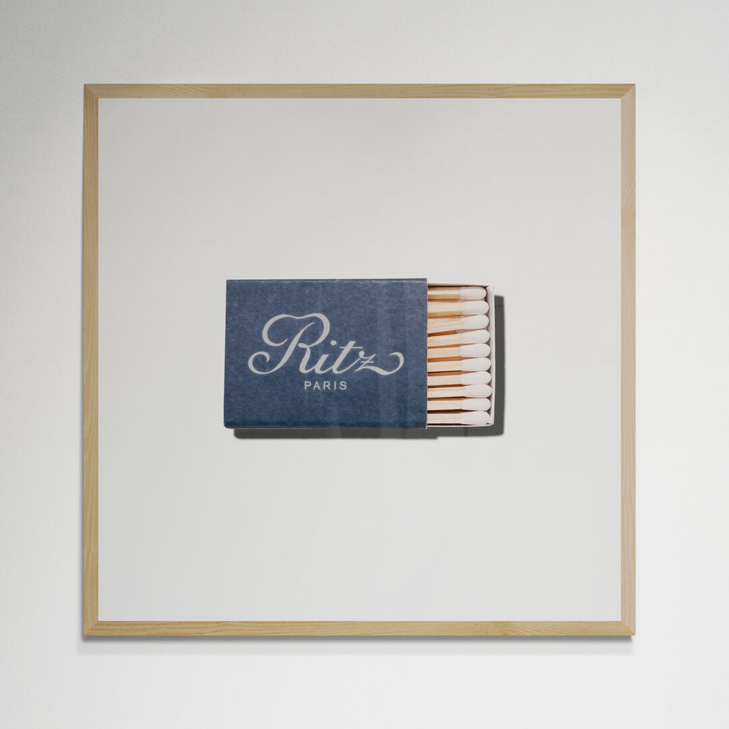 Ritz Paris matchbook print in natural wood frame on wall