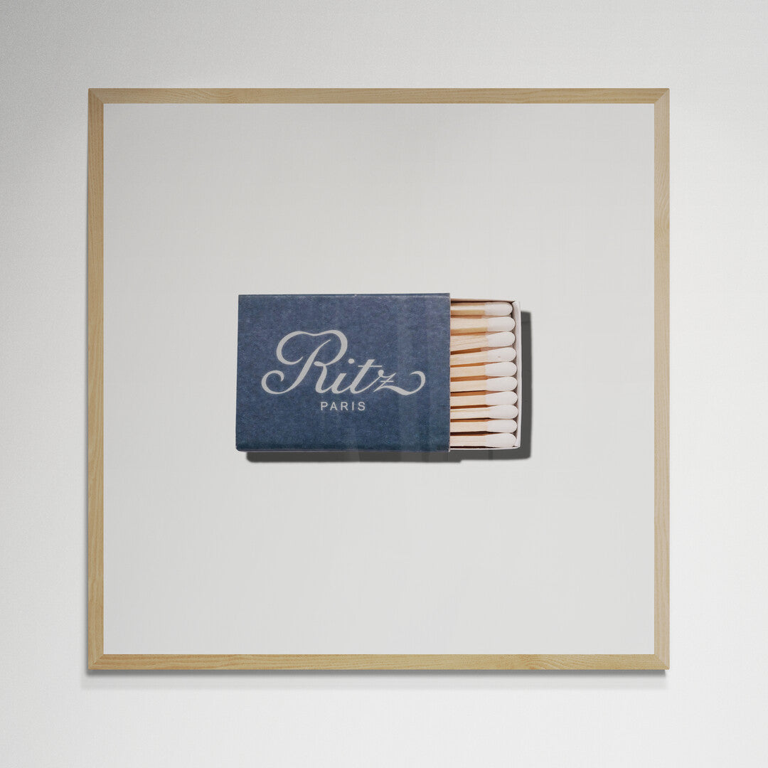 Ritz Paris matchbook print in natural wood frame on wall