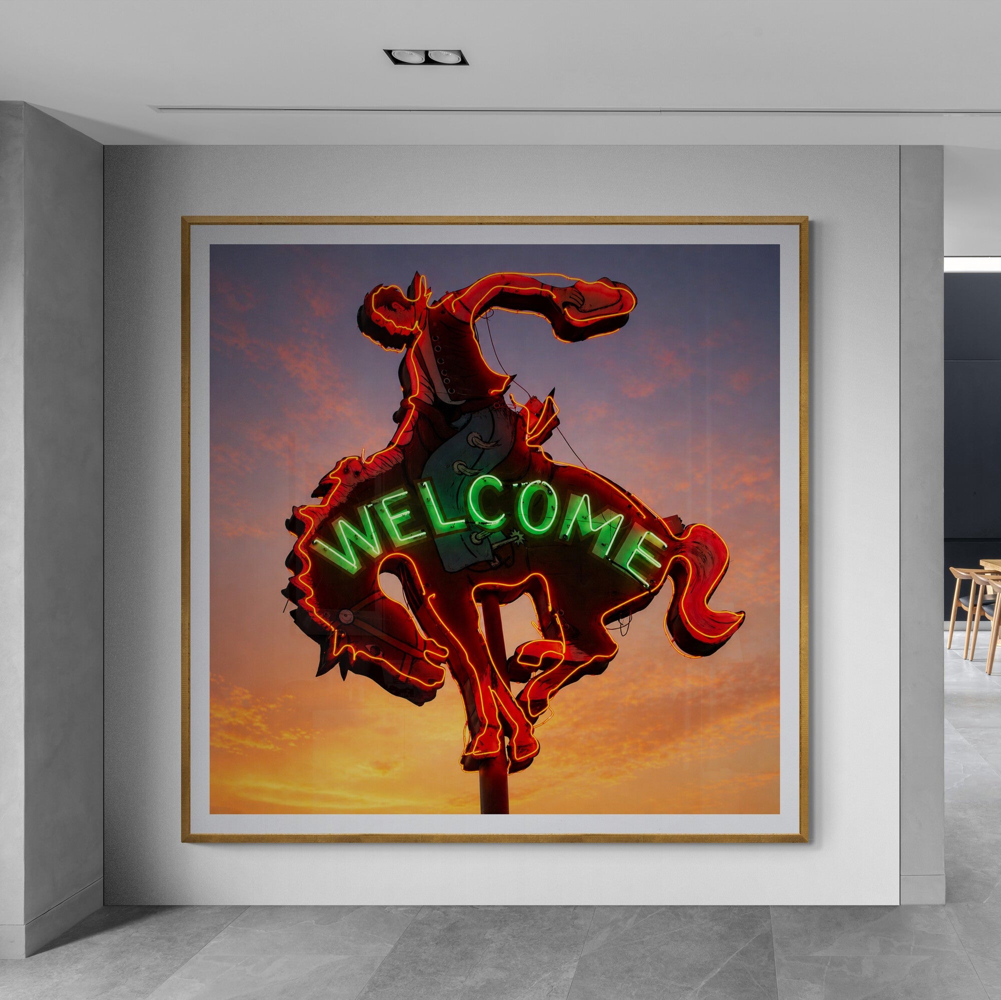 Neon sign of a bucking bronco with 'WELCOME' below in a modern interior setting.